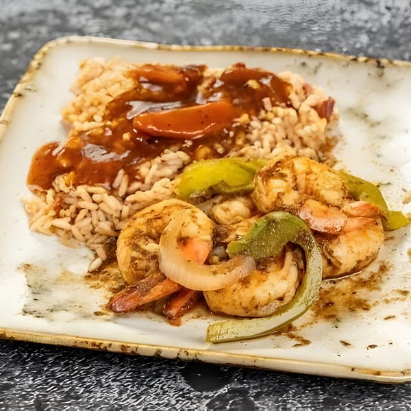 Jerk N Go's Jamaican shrimp and rice dish, with brown gravy, onions, and green peppers.