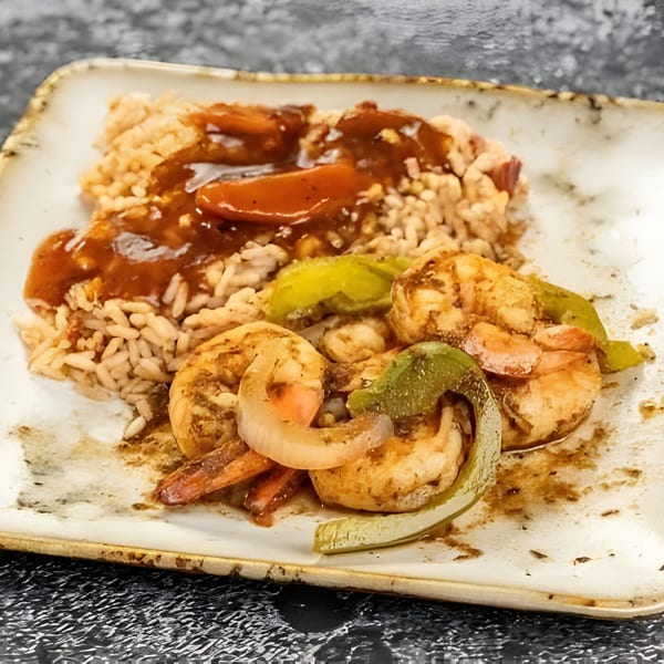 Jerk N Go's Jamaican shrimp and rice dish with brown gravy, green peppers, and onions.
