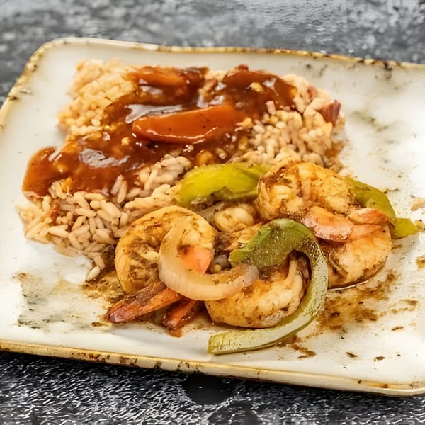 Jerk N Go's Jamaican shrimp and rice dish, with peppers, onions, and a rich brown sauce.
