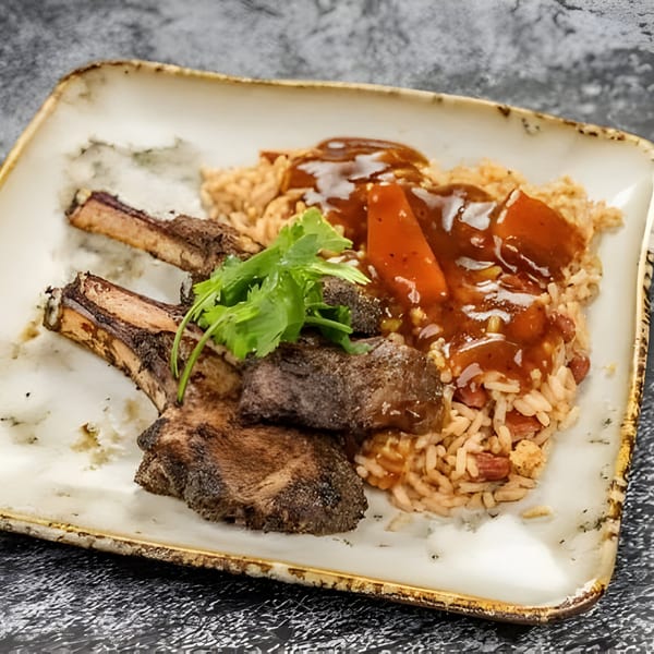Jerk N Go's Jamaican jerk lamb chops with rice and peas, topped with brown gravy and cilantro.